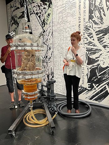 Foto vom Ausflug zum ZKM Karlsruhe. Das Bild zeigt Frau Geng vor einem Kunstwerk, dem biochemischen Labor