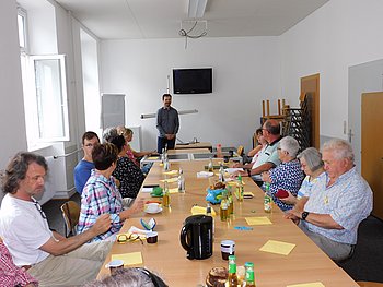 Bei einem Regionalgruppentreffen der RG Trier, hören mehrere Personen Christian Neukirch bei seinem Vortrag zu